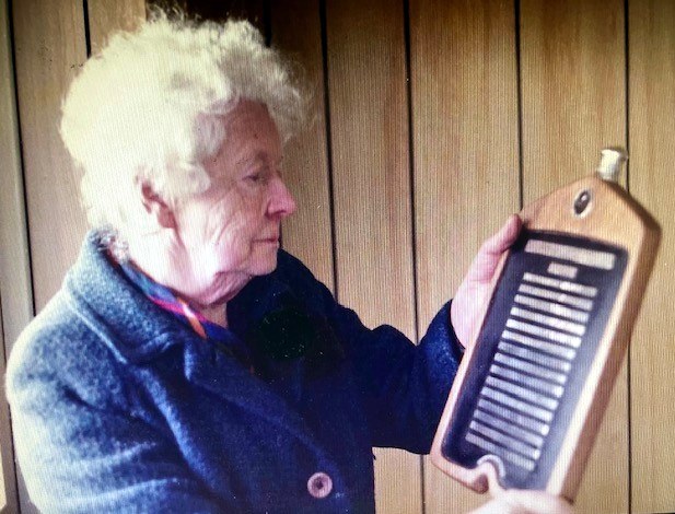Mrs George Lanchester admiring the Lanchester Register Shield in 1984